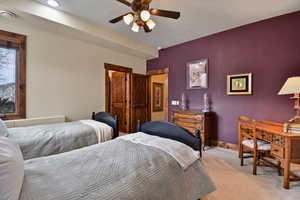 Carpeted bedroom with ceiling fan