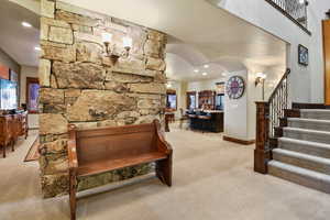 Living room featuring ceiling fan and light colored carpet