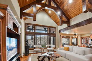 VIRTUALLY STAGED - Living room with ceiling fan, wooden ceiling, beamed ceiling and light hardwood / wood-style floors