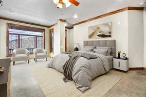 VIRTUALLY STAGED -Carpeted bedroom featuring ceiling fan and ornamental molding