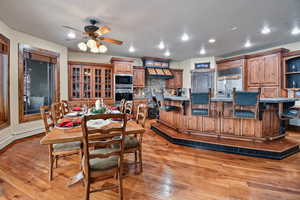 Dining room with light hardwood / wood-style floors and ceiling fan