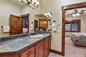 Bathroom with vanity, ceiling fan