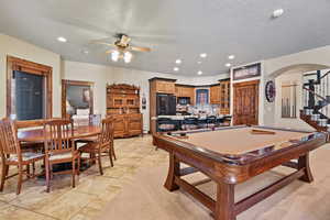 Playroom with ceiling fan, light tile patterned floors, and pool table