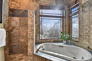 Bathroom with a relaxing tiled tub