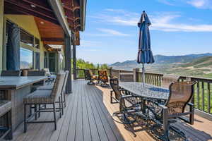 Wooden terrace featuring a mountain view