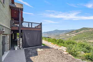 View of yard with a mountain view and a balcony