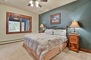 Carpeted bedroom with ceiling fan