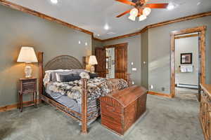 Carpeted bedroom with ceiling fan.