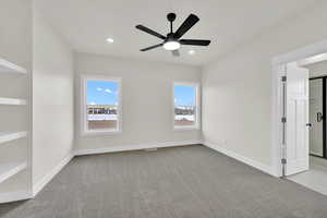 Unfurnished room with plenty of natural light, light colored carpet, and ceiling fan