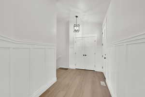 Entrance foyer featuring a chandelier and light hardwood / wood-style flooring