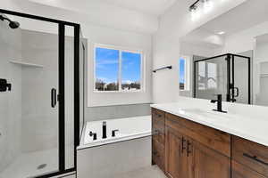 Bathroom with vanity and shower with separate bathtub