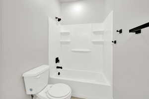 Bathroom with toilet and washtub / shower combination