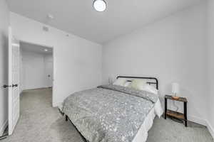 Bedroom with visible vents, baseboards, and carpet