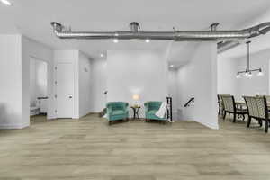 Living area featuring visible vents, baseboards, and light wood-type flooring