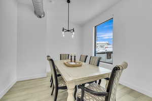 Dining space featuring light wood-style floors and baseboards