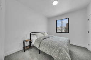 Carpeted bedroom with baseboards