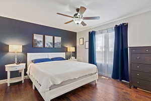 Bedroom with ceiling fan and dark hardwood / wood-style floors