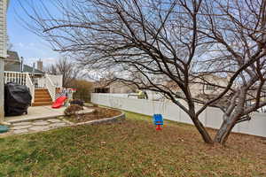 View of yard featuring a patio and a deck