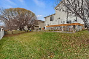 View of yard with a wooden deck