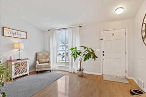 Entrance foyer with light hardwood / wood-style flooring