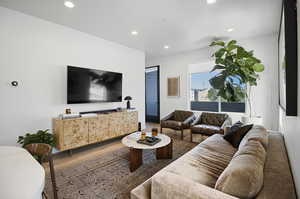 Living room featuring oversize windows and vinyl flooring