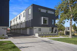 View of building exterior featuring a 1 car garage