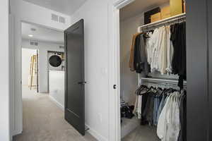 Primary suite walk in closet and bedroom entrance