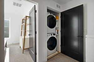 Laundry room featuring stacked washer and dryer