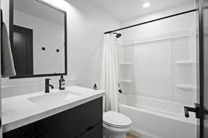 Full bathroom with quartz countertop vanity, shower/bathtub combination