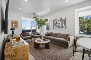 Living room featuring oversize windows and vinyl flooring