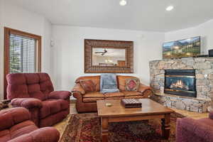 Living room with ceiling fan and a fireplace