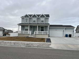 View of front of house featuring a porch and a garage