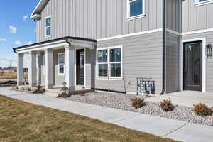 Property entrance with a lawn and a porch