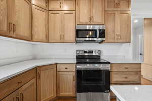 Kitchen featuring light stone countertops and stainless steel appliances