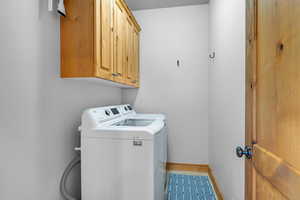 Laundry room with cabinets and washing machine and clothes dryer