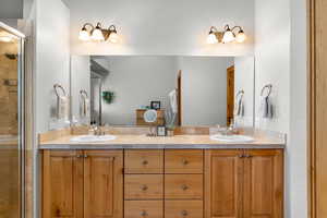 En suite master Bathroom featuring vanity and a shower with shower door