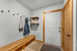 Mudroom with light tile patterned floors