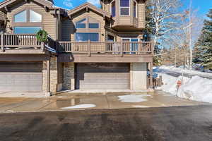 View of front of house featuring a two-car garage and private driveway parking