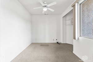 Spare room with carpet flooring and ceiling fan