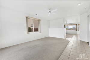 Unfurnished room featuring ceiling fan and light tile patterned flooring