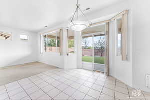 Unfurnished dining area featuring light colored carpet