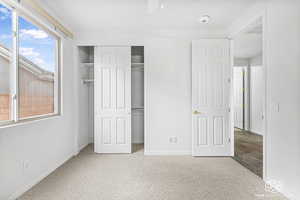 Unfurnished bedroom with carpet flooring