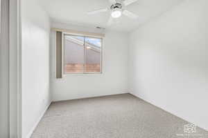 Unfurnished room with ceiling fan and carpet floors