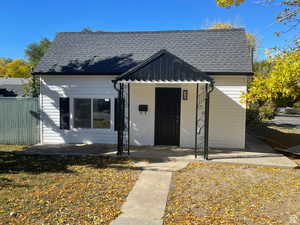 Bungalow-style house with an outbuilding and a patio