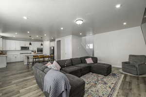 Living room with light hardwood / wood-style flooring and a textured ceiling