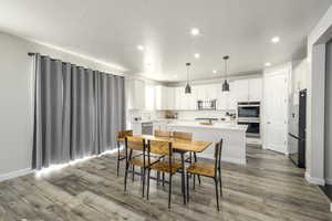 Dining area with hardwood / wood-style flooring