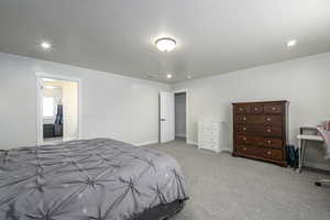 Carpeted bedroom with a textured ceiling