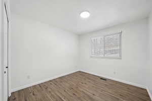 Spare room featuring dark hardwood / wood-style floors