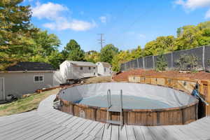 View of swimming pool with a wooden deck