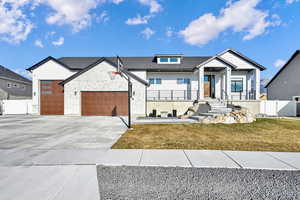 View of front of home featuring a front yard and a garage